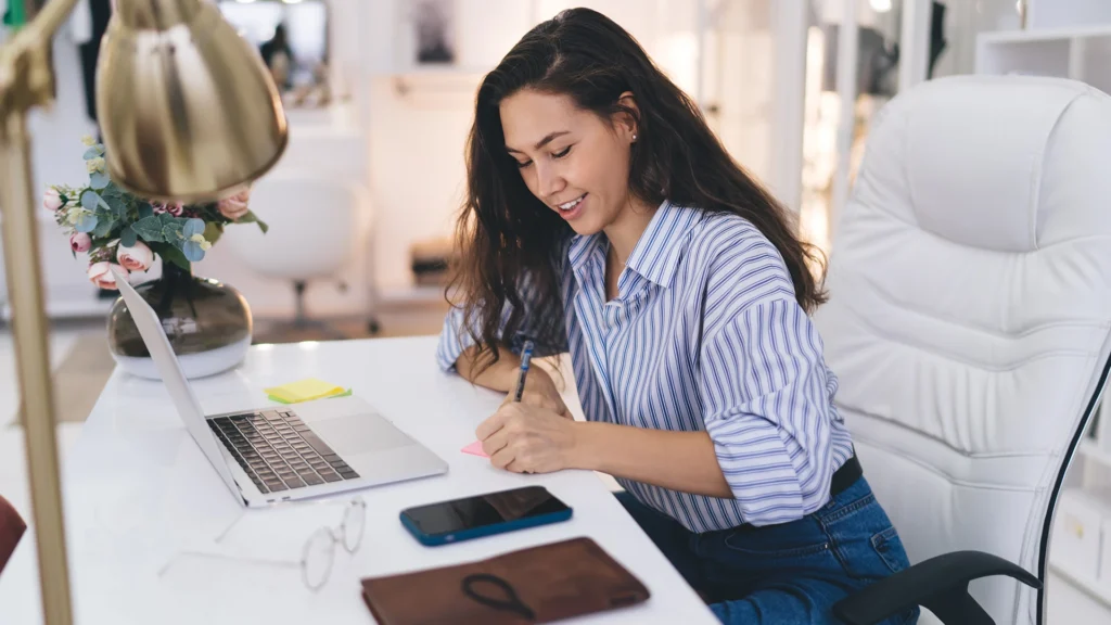 PN Inclusion - Making communication accessible for everyone, everywhere - Professional Notetaking Services Image of Lady Taking Notes in front of laptop